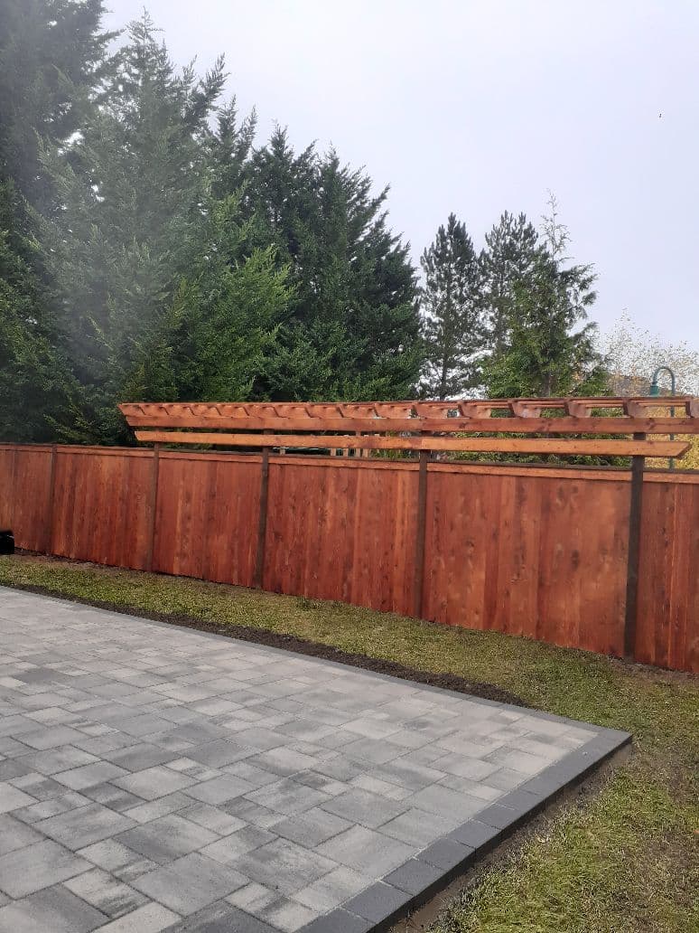 Cedar fence with pergola and paver patio area